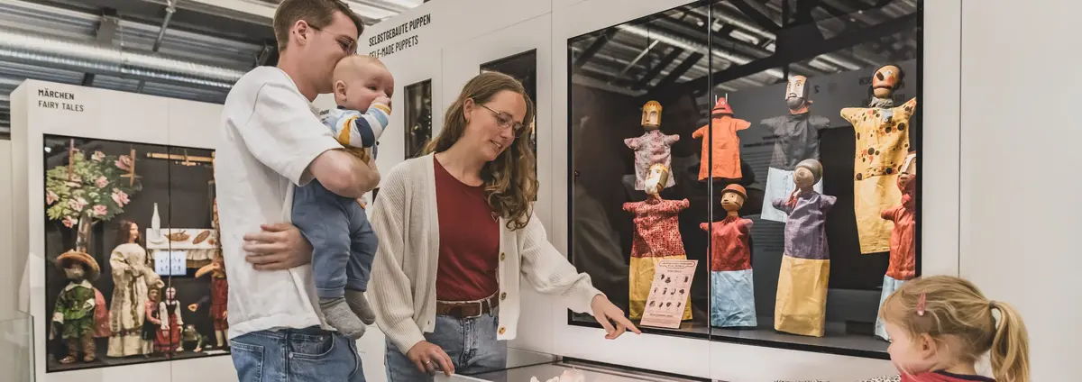 Besucherinnen in der Ausstellung an einer Schublade