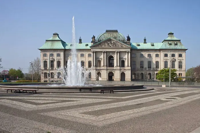 Japanisches Palais von außen, davor ein Brunnen mit Wasserfontäne