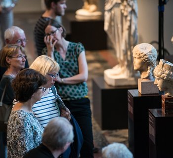 Besucher, die sich Büsten und Skulpturen anschauen