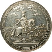 Medaille, darauf Mann in Rüstung auf einem Pferd